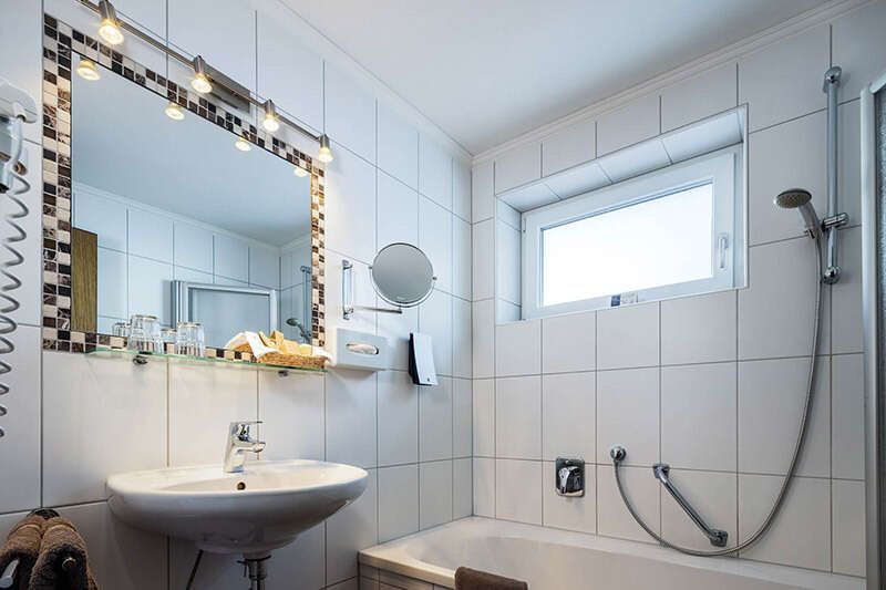 Bathroom with tub in the family room in Hotel Schlossberg