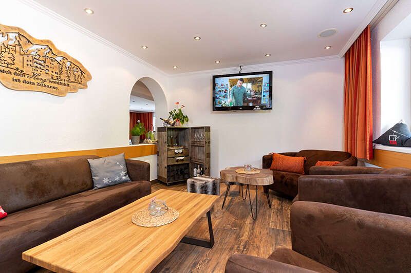 Lounge area with TV in Hotel Schlossberg